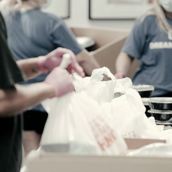 Hands packing food into bags